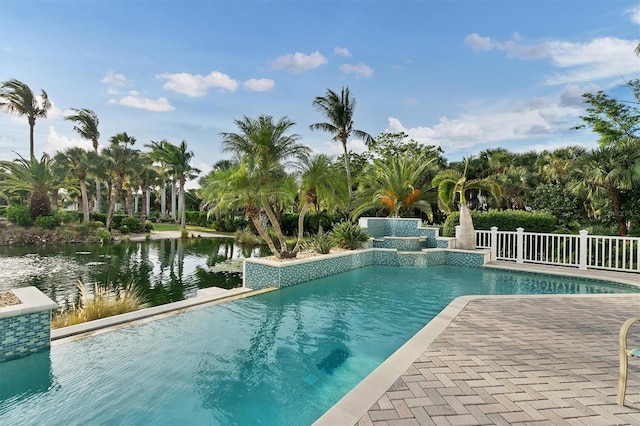 view of swimming pool featuring a patio and a water view