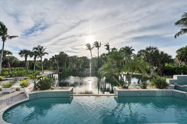 view of pool with a water view