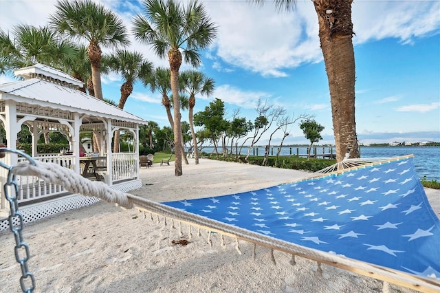 exterior space featuring a gazebo and a water view