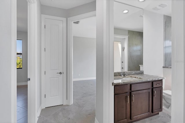 bathroom with vanity, toilet, and tile flooring