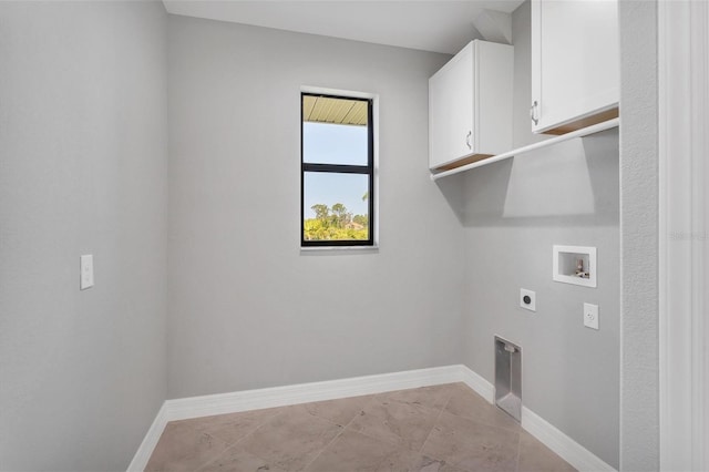 laundry area featuring hookup for an electric dryer, cabinets, light tile floors, and washer hookup