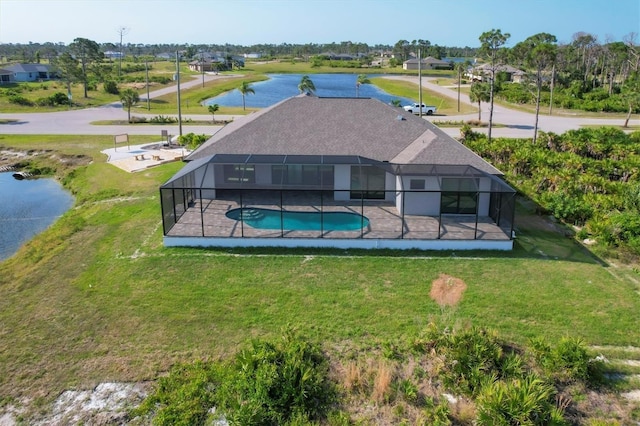 rear view of property with a lanai, a water view, and a lawn