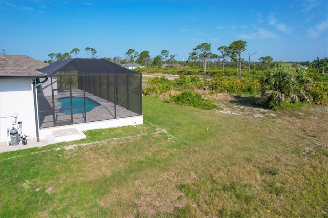 view of yard featuring a patio area and glass enclosure