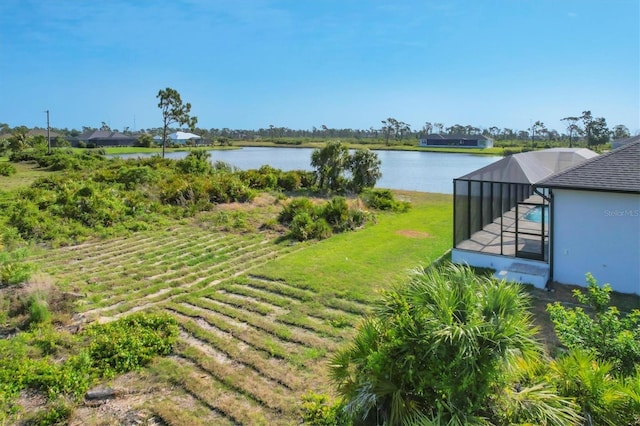 view of yard with a water view and a lanai