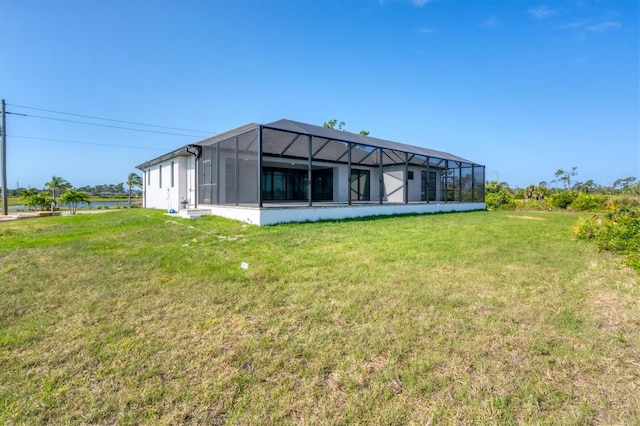 back of property featuring a yard and a lanai