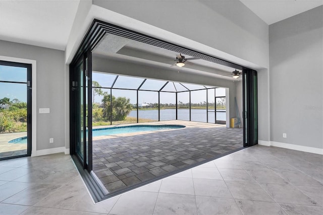 doorway to outside with ceiling fan and light tile floors