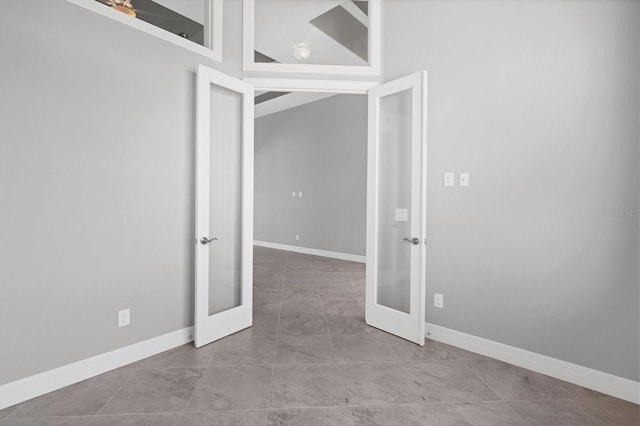 tiled spare room with french doors