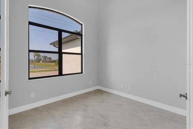 tiled empty room with a healthy amount of sunlight