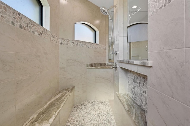 bathroom with a tile shower