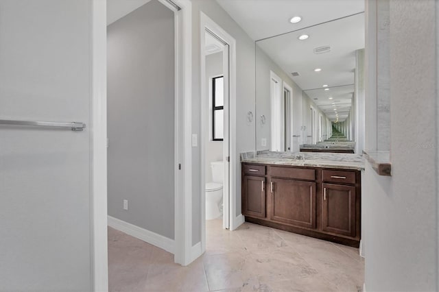 bathroom featuring toilet, tile floors, and vanity