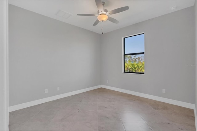 tiled spare room with ceiling fan