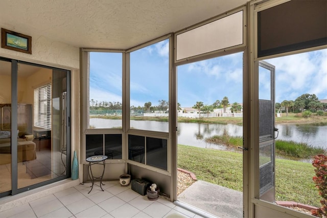 sunroom with plenty of natural light and a water view