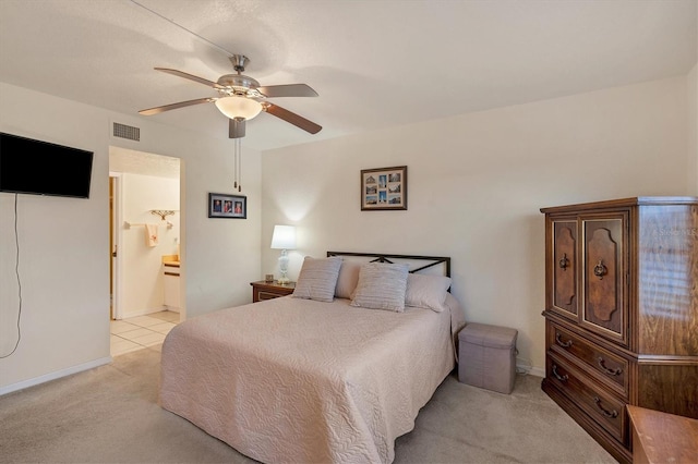 carpeted bedroom featuring ensuite bath and ceiling fan