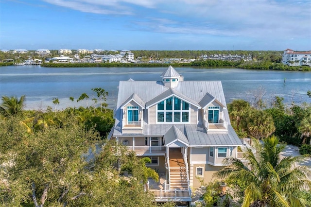 view of front of property with a balcony and a water view