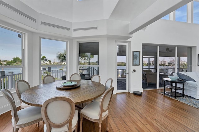 dining room featuring a high ceiling and hardwood / wood-style flooring