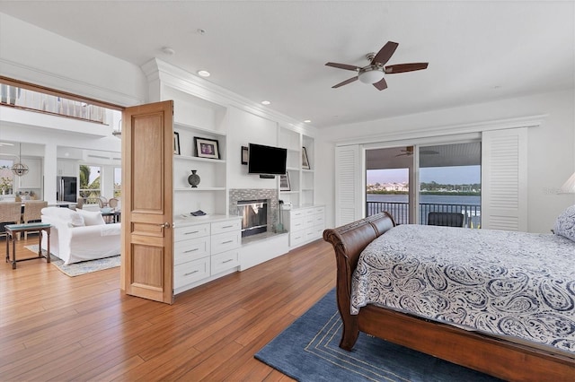 bedroom featuring access to outside, light hardwood / wood-style floors, and ceiling fan