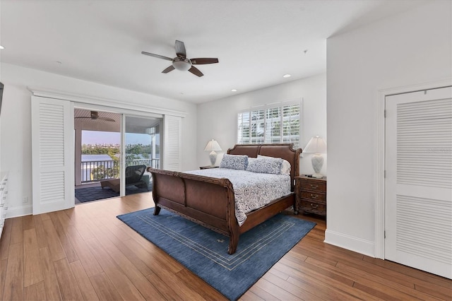 bedroom featuring hardwood / wood-style flooring, ceiling fan, access to outside, and a closet