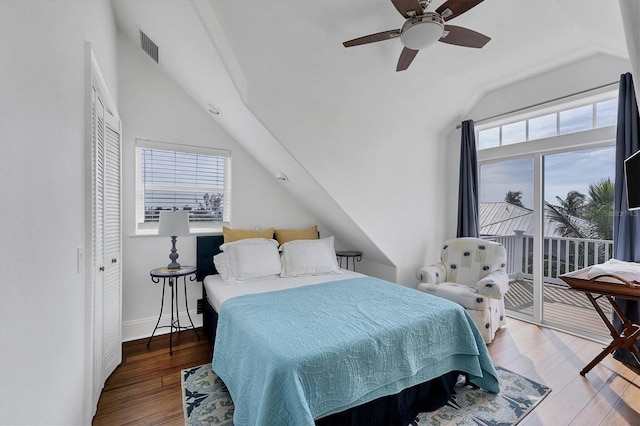 bedroom with hardwood / wood-style flooring, vaulted ceiling, a closet, and ceiling fan