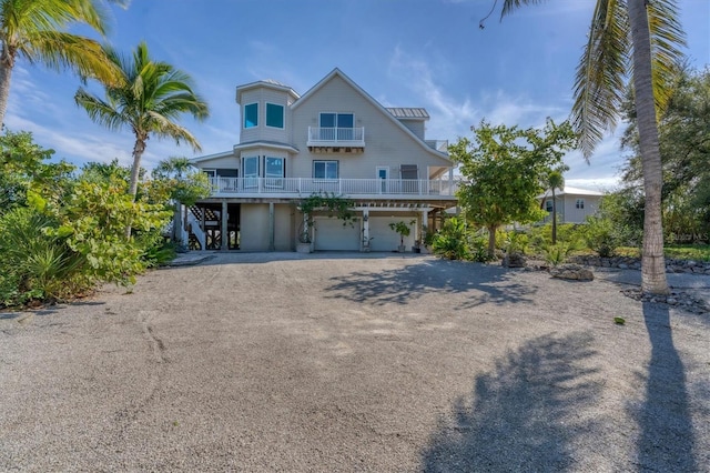 view of front of home with a balcony and a garage