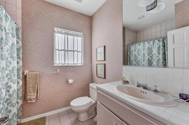 bathroom featuring vanity, tasteful backsplash, tile patterned floors, walk in shower, and toilet