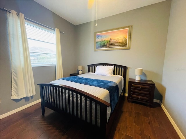 bedroom with dark hardwood / wood-style flooring