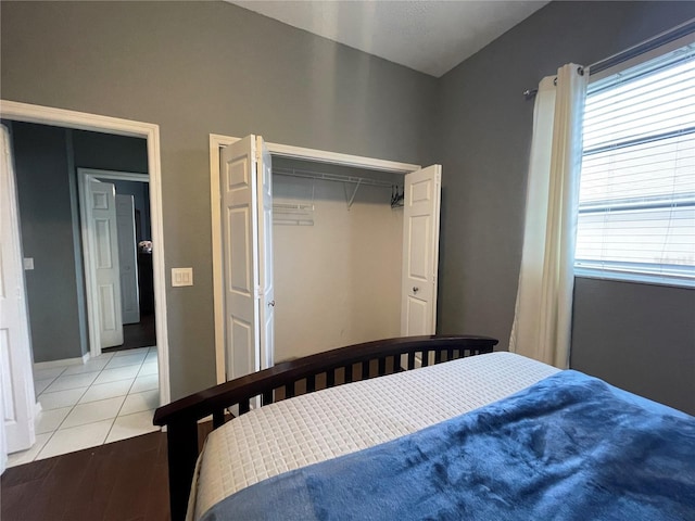 bedroom with light hardwood / wood-style flooring and a closet