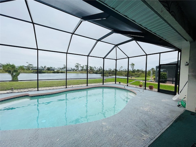 view of swimming pool with a lanai, a patio area, a lawn, and a water view