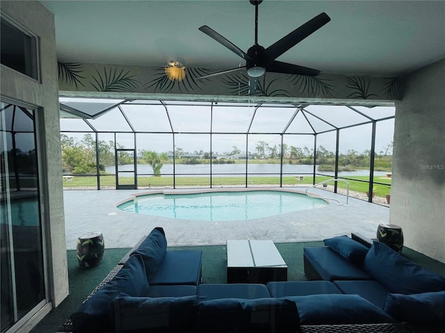 view of swimming pool featuring outdoor lounge area, ceiling fan, a patio, and glass enclosure