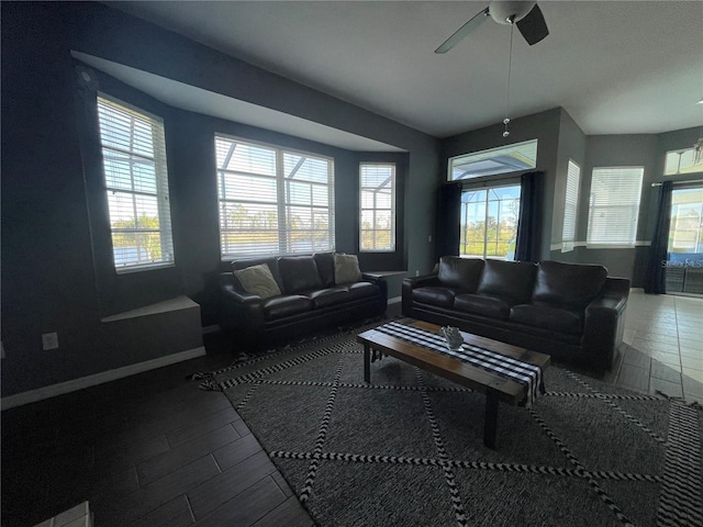 living room featuring ceiling fan and a healthy amount of sunlight