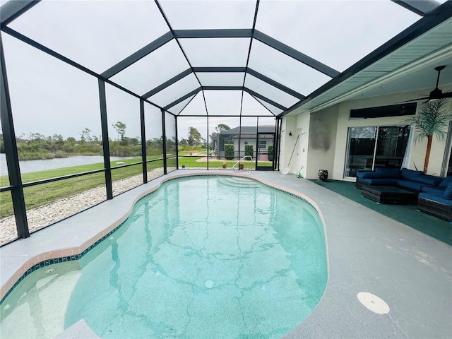 view of swimming pool with a patio, a water view, and glass enclosure