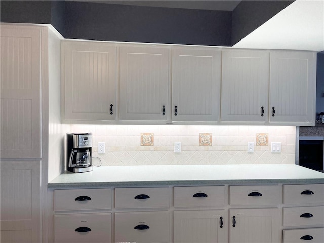 kitchen featuring decorative backsplash and white cabinets