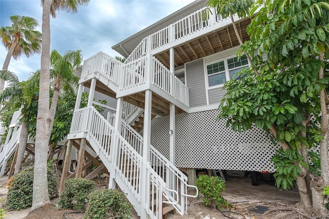 back of house featuring a wooden deck