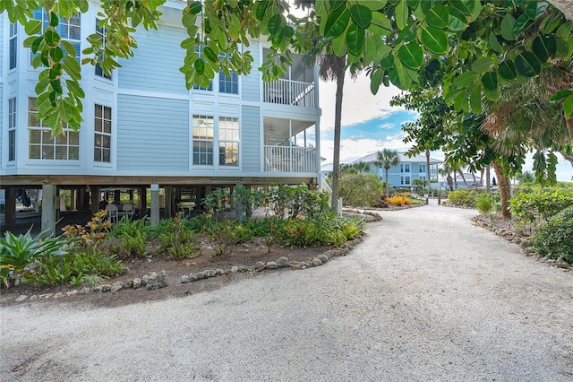 view of side of property with a balcony and a carport