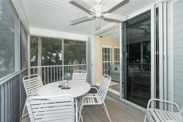 sunroom / solarium featuring ceiling fan