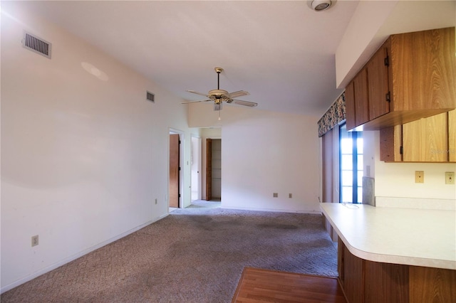 unfurnished living room with light carpet and ceiling fan