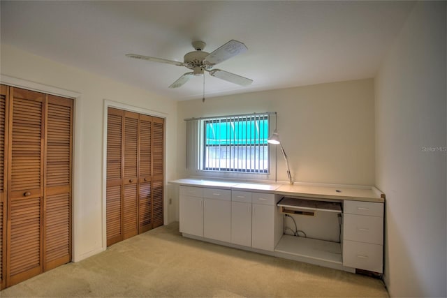 unfurnished office with light carpet and ceiling fan