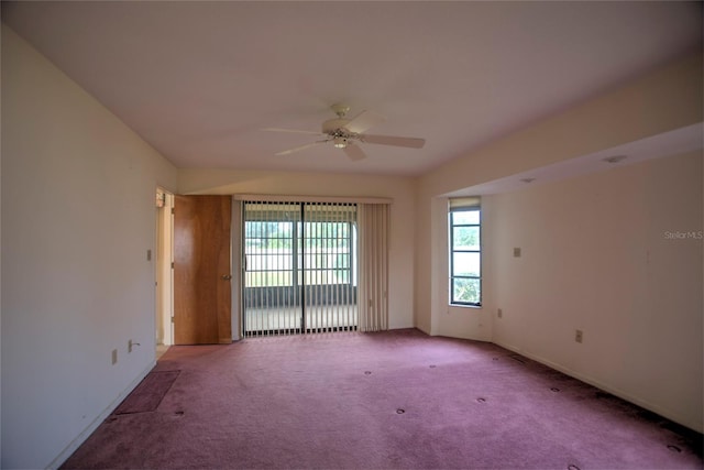 carpeted spare room featuring ceiling fan