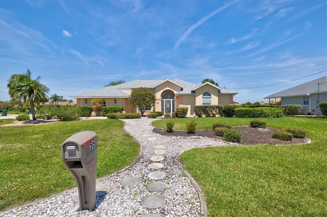 ranch-style home featuring a front yard