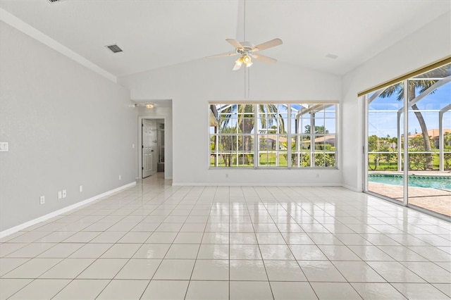 spare room with vaulted ceiling, ceiling fan, and light tile patterned flooring