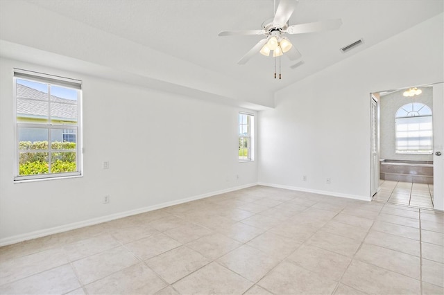 tiled empty room with ceiling fan and lofted ceiling