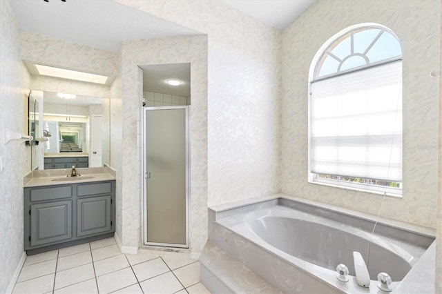 bathroom featuring tile patterned floors, vanity, a healthy amount of sunlight, and plus walk in shower