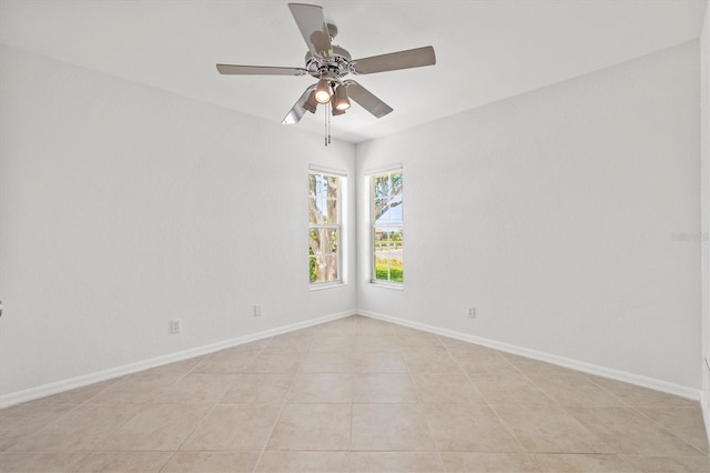 spare room with light tile patterned floors and ceiling fan