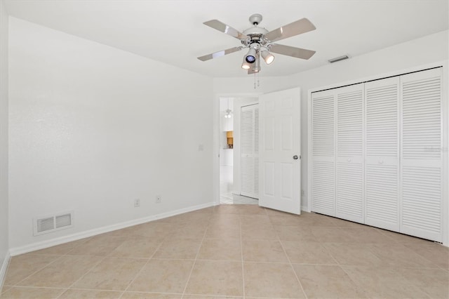 unfurnished bedroom with ceiling fan and light tile patterned flooring