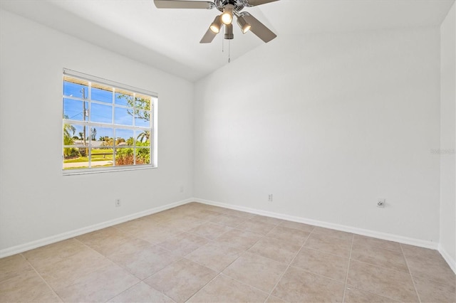 unfurnished room featuring ceiling fan, light tile patterned floors, and vaulted ceiling