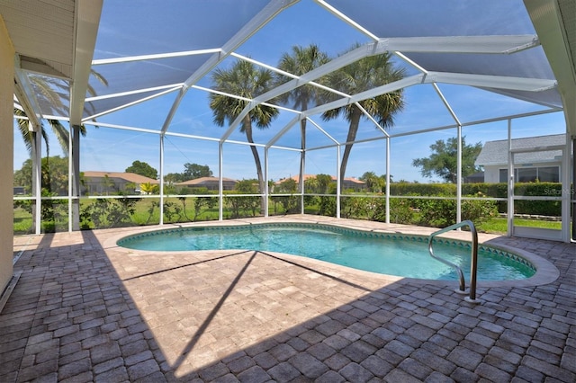 view of swimming pool with glass enclosure and a patio area