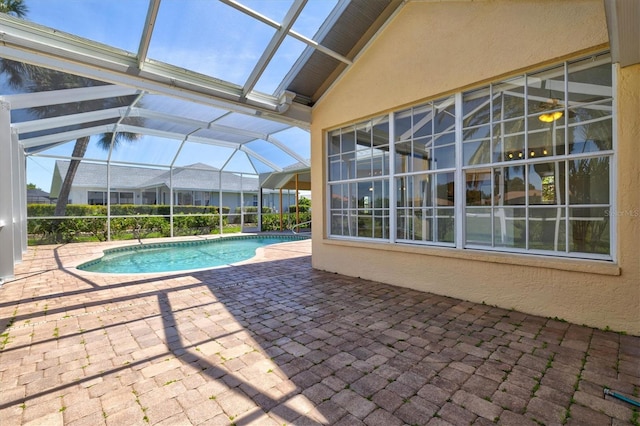 view of swimming pool with glass enclosure and a patio area