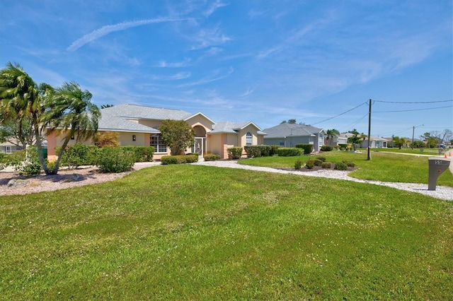 ranch-style home featuring a front lawn