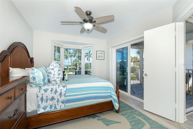 bedroom featuring access to exterior, ceiling fan, light hardwood / wood-style flooring, and multiple windows