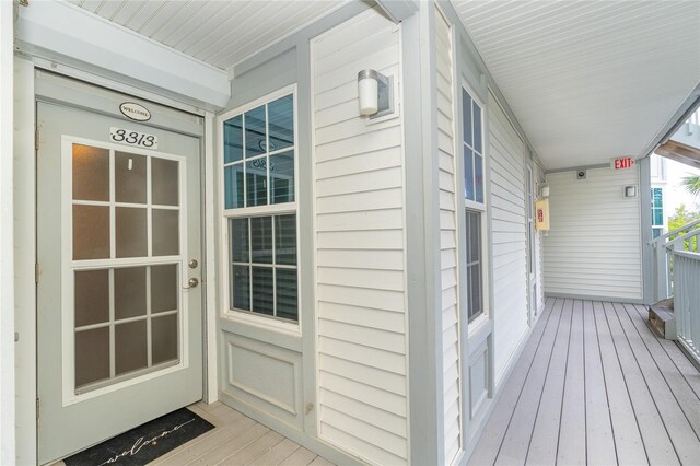 view of exterior entry with covered porch