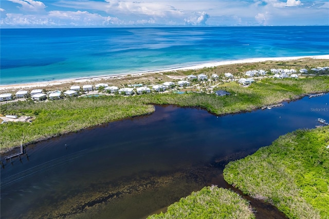 bird's eye view with a water view and a view of the beach